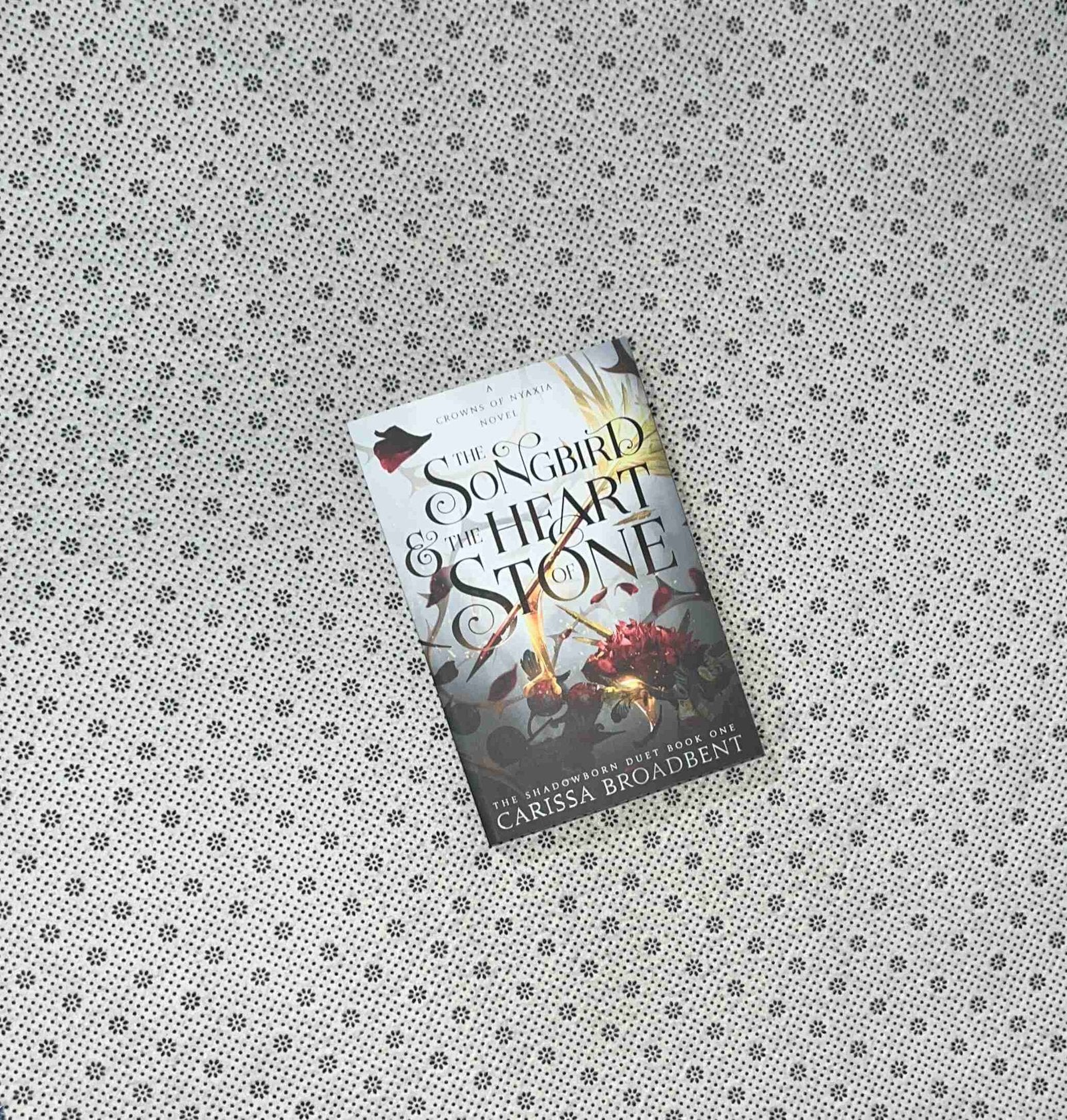 the songbird and the heart of stone crowns of nyaxia series book 3 by carissa broadbent